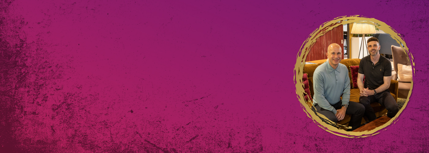 purple banner with image of two men in a circular cut-out